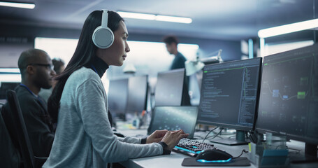 Portrait of a Thoughtful Young Engineer Working on Computer in a Technological Office Environment....