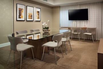 Fototapeta premium meeting room with modern furnishings, sleek design, and glass tabletop for a contemporary feel, created with generative ai