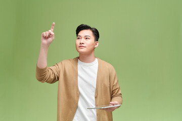 Isolated portrait of student holding tablet and pointing in the air