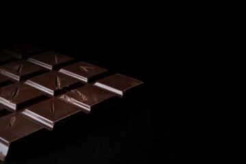 chocolate bar on black background with copy space for your own advertisement, created with generative ai