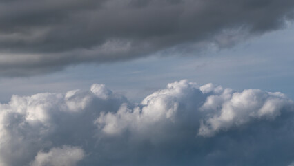 Gray cumulus clouds in the sky. Dramatic skies, landscape. The sky is like a background. White clouds, blue sky