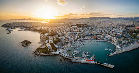 Aerial sunset panorama of the Piraeus district in Athens, Greece, with Mikrolimano and Zea Marina and the ferry boat harbour in the background