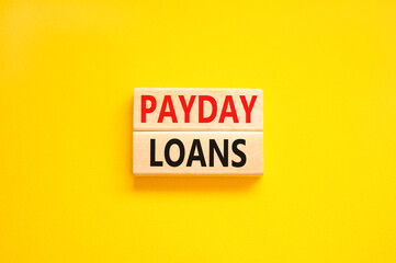 Payday loans symbol. Concept words Payday loans on beautiful wooden block. Beautiful yellow table yellow background. Business and Payday loans concept. Copy space.