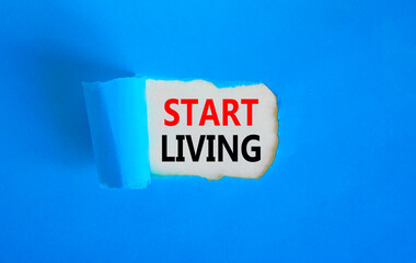 Start living symbol. Concept words Start living on beautiful white paper. Beautiful blue table blue background. Business and Start living concept. Copy space.