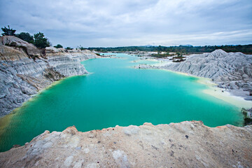 Fototapeta premium Exotica of Blue and Green Kaolin Lake in Bangka, Bangka Belitung, Indonesia. This lake is a former tin mining excavation area which is widely found on Bangka Island.