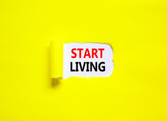 Start living symbol. Concept words Start living on beautiful white paper. Beautiful yellow table...