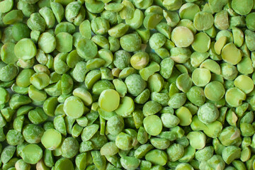 Poured dry green peas background. Raw organic split pea groat