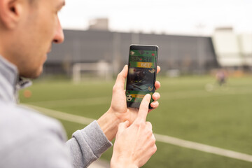 Man using online sports betting services on phone