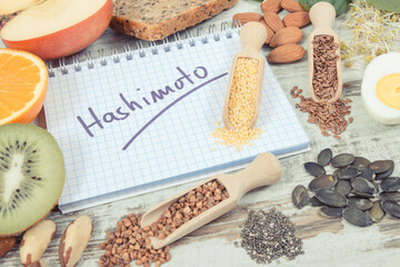 Fototapeta na wymiar Notepad with inscription hashimoto and best ingredients or products for healthy thyroid. Food containing vitamins
