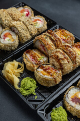 delicious japanese food from chef on black background. Delivery
