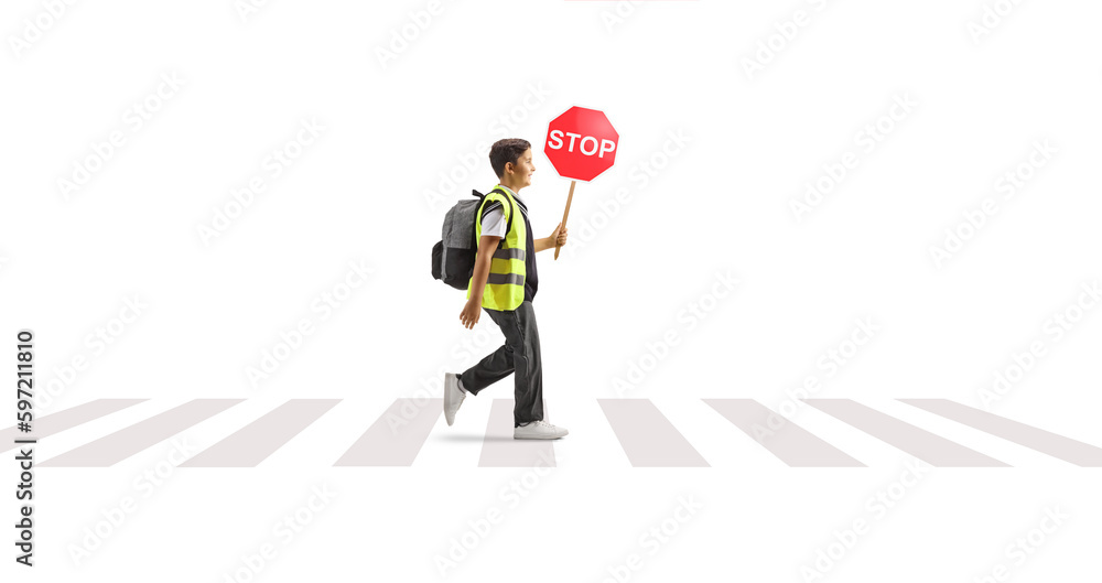 Sticker full length profile shot of a schoolboy wearing a reflective vest and carrying stop sign at a pedest