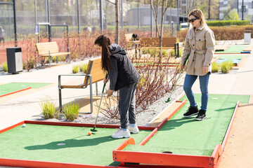 Obraz na płótnie Canvas Family Time Playing Mini-Golf In The Summer