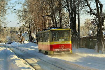 Winter sunny day, red tram