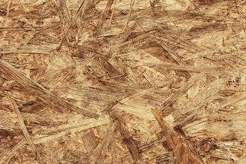 OSB board texture. Brown wooden background. Simple pressed chipboard pattern. Chip board background. Brown wood texture.	