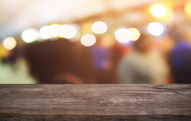 Empty dark wooden table in front of abstract blurred bokeh background of restaurant . can be used for display or montage your products.Mock up for space.