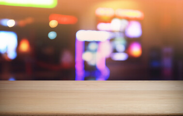 Empty dark wooden table in front of abstract blurred bokeh background of restaurant . can be used for display or montage your products.Mock up for space.