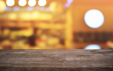 Empty dark wooden table in front of abstract blurred bokeh background of restaurant . can be used for display or montage your products.Mock up for space.