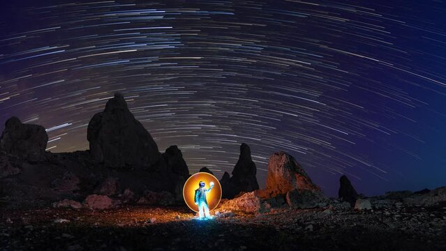 Astronaut in an Unusual Landscape With Stars Time Lapsed
