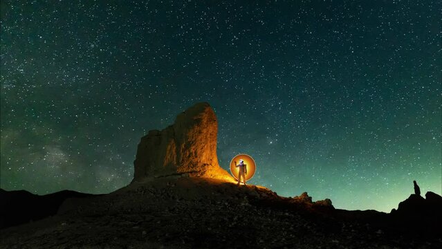 Light Painted Astronaut in an Unusual Landscape With Stars Time Lapsed