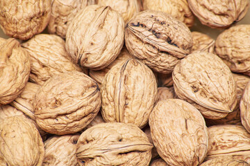 Stacked unpeeled solid walnuts pattern texture background