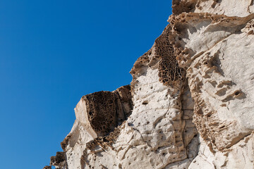 unusual rock formations of the volcanic cliff on Cala Sapone beach, quartz-trachitic ignimbrites.