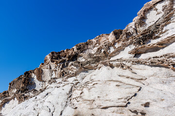 Fototapeta na wymiar unusual rock formations of the volcanic cliff on Cala Sapone beach, quartz-trachitic ignimbrites.