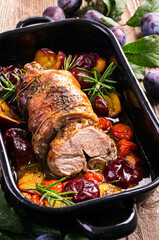 Traditional French barbecue lamb roast with vegetable and plums served as close-up in a rustic...