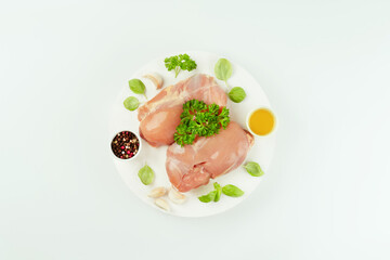 Fresh raw skinless chicken thigh meat with fresh herbs on a gray background.Copy space.Food for retail.Ogranic food,healthy eating.Food concept.Top view.