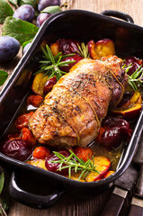 Traditional French barbecue lamb roast with vegetable and plums served as close-up in a rustic...