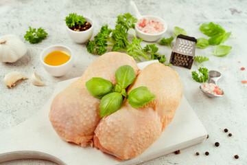 Chicken leg meat.Food for retail.Procurement for designers.Ogranic food,healthy eating.Food concept.Top view.Chicken leg meat with skin with fresh herbs.