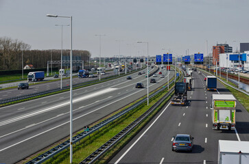 Rotterdam, The Netherlands, April 5, 2023: view from a viaduct towards the A15 motorway with traffic on a total of 14 lanes