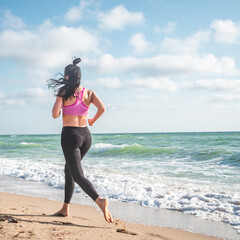 Fitness Girl running on the beach