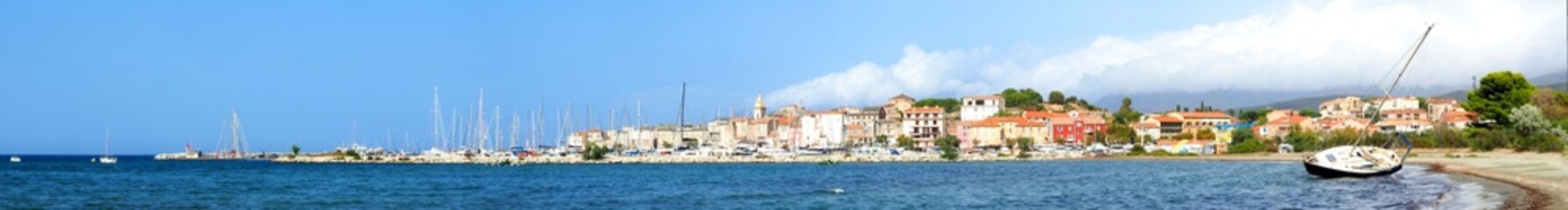 Fototapeta na wymiar Panoramic view of the page and the marina of the famous seaside resort of Saint Florent, capital of the Nebbio region in Corsica, nicknamed the Island of Beauty