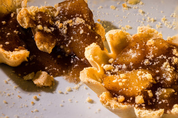 100mm Macro of Apple Tartlets, small tarts, small pie, crumbs, shortbread crust and broken in pieces. 