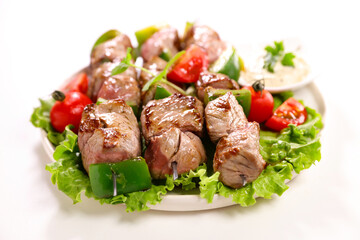 grilled beef skewer,  sauce and salad