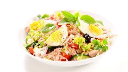mixed rice salad with egg, tunat, tomato and olive on white background