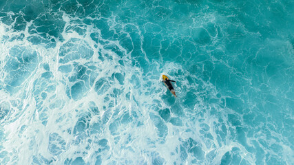 Surfer paddling in the ocean 