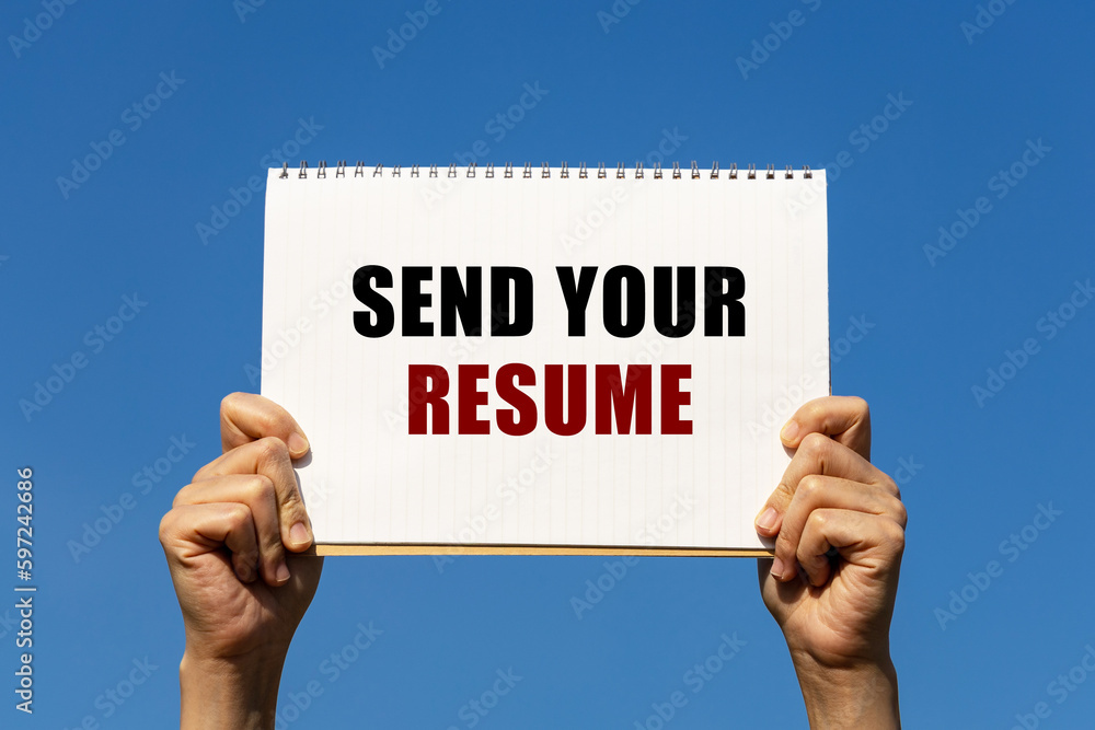 Poster send your resume text on notebook paper held by 2 hands with isolated blue sky background. this mess