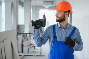 Construction worker use a drill bit