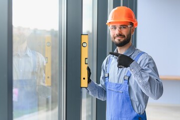 service man installing plastic window.