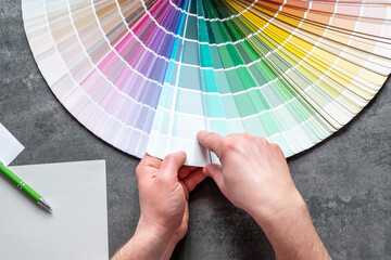 Designer or architect choosing samples the colors painting of the walls into room. interior design...
