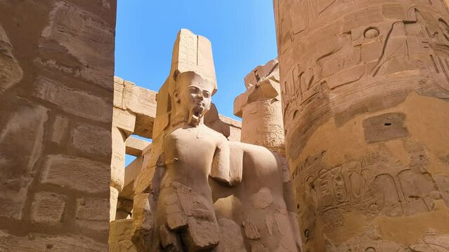 A dilapidated statue of the Pharaoh in front of the Karnak Temple in Egypt.