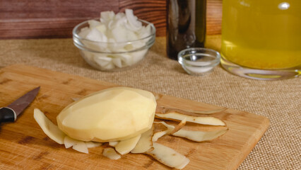 Peeling and cutting potatoes. Vegetables soup recipe. Fresh raw vegetables close-up