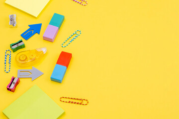 Stationery, paper clips, stickers on a yellow background as a concept of fun office work