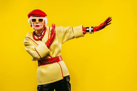 Cool and stylish senior old woman with fashionable clothes - Elderly funny female with stylish colorful dress portrait on isolated colored background