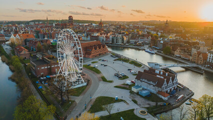 Panorama of Gdańsk with a view of the Motława River, the Old Town and the observation wheel at sunset at the end of April.