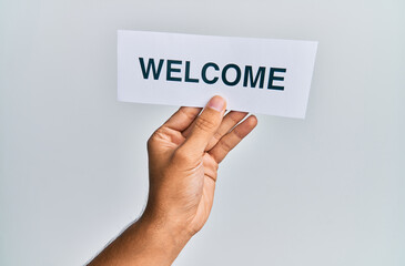 Hand of caucasian man holding paper with welcome word over isolated white background