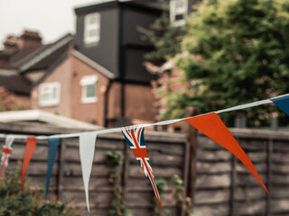 Flags of Great Britain waving on the wind in the garden of English