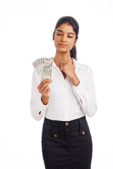 Business woman thinking with Indian currency isolated on white.