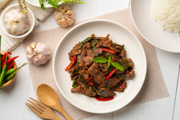 Stir fried sliced Beef with Holy Basil in white plate.Thai famous food (Pad Kra pao).Top view - obrazy, fototapety, plakaty